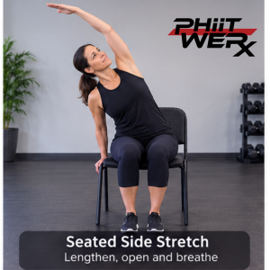 Person seated in a chair reaching one arm overhead for a gentle side stretch during Chair Yoga.